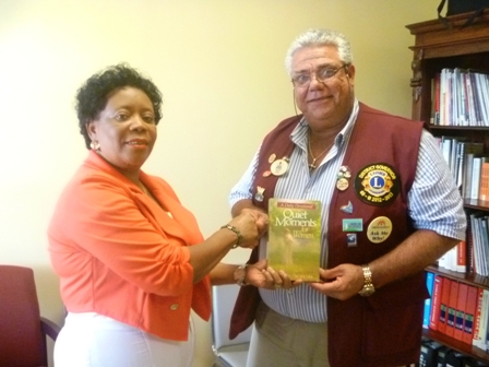 District Governor Zone 60B Mr. Claudius ‘Tony’ Boncamper MJF hands over books to Director of the Nevis Library Services Mrs Sonita Daniel